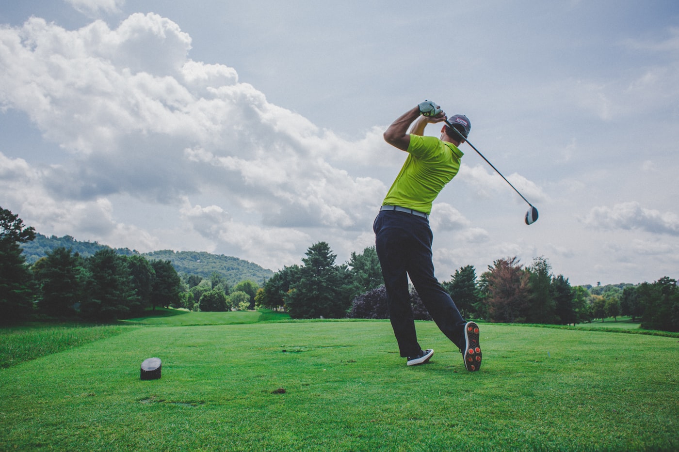 Golfer teeing off on a course